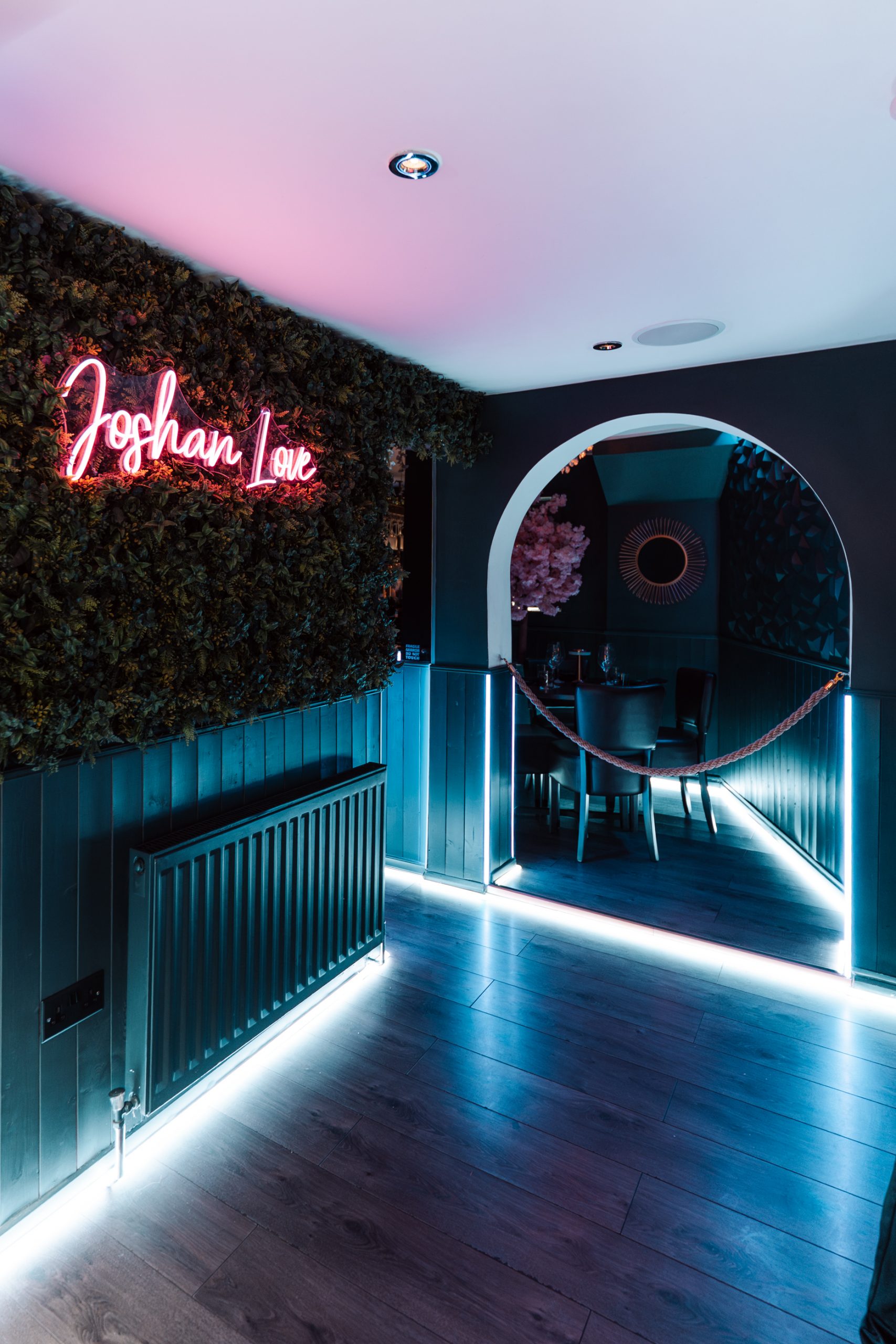 Joshan of Wye Indian restaurant neon-lit entrance corridor, Ashford