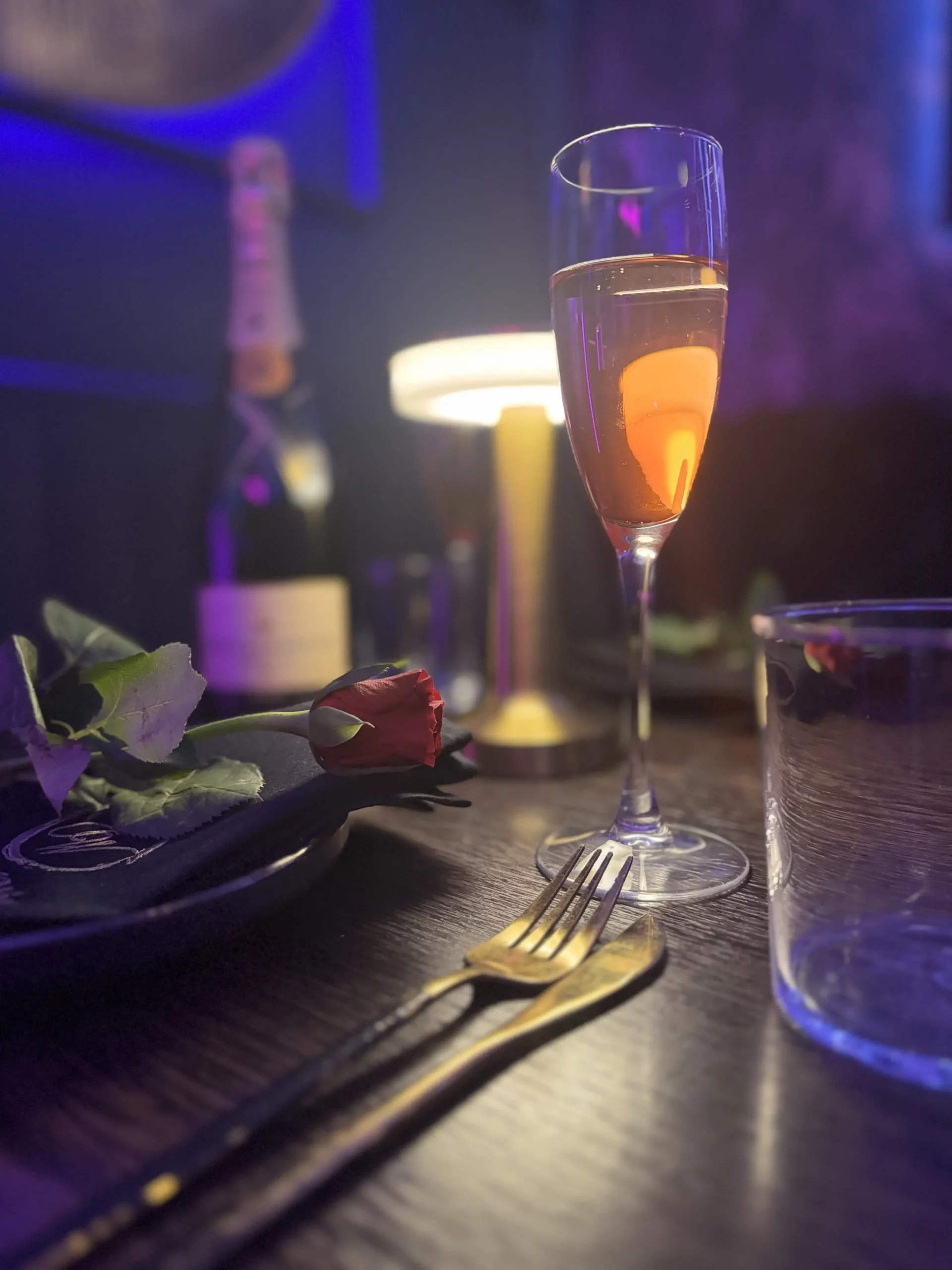 Romantic candlelit table setting with champagne and rose at Joshan of Wye, Ashford